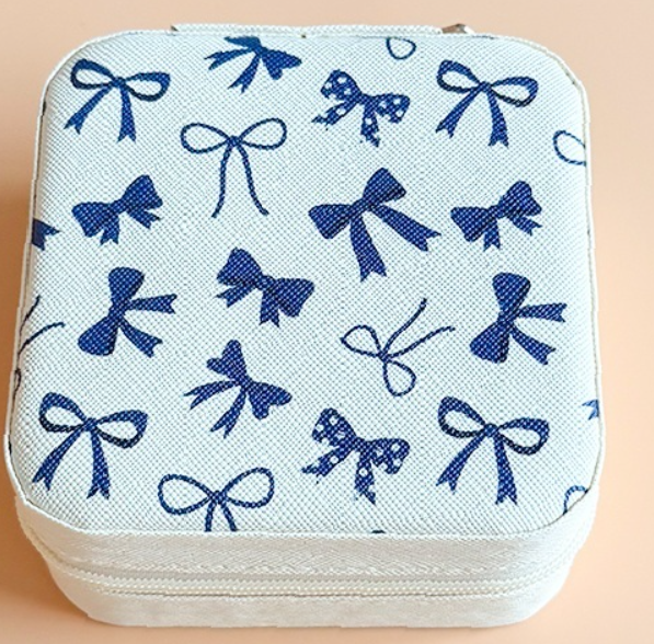 Colorful patterned travel jewelry organizer case with compact weather-resistant design for storing rings, earrings, necklaces, and bracelets.