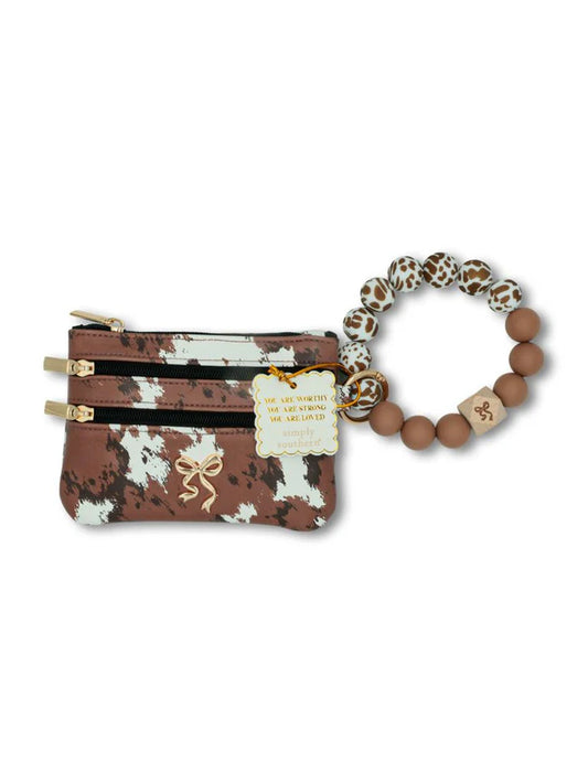 Brown and cream cow print double zip coin pouch with gold bow accent and matching silicone beaded wristlet keychain featuring an inspirational affirmation charm.