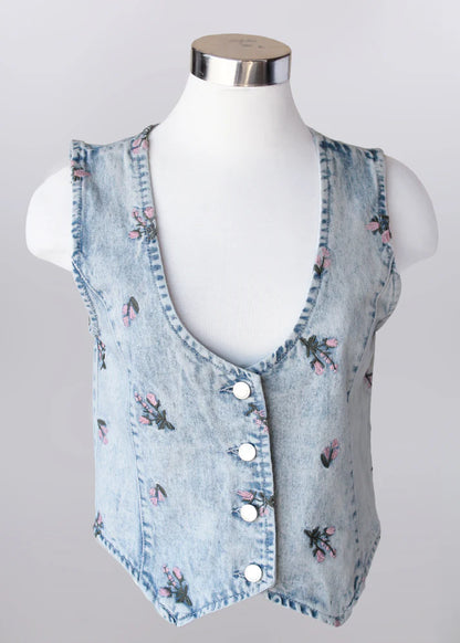Floral embroidered light wash denim vest made from 100% cotton, styled as a lightweight layering piece for spring outfits