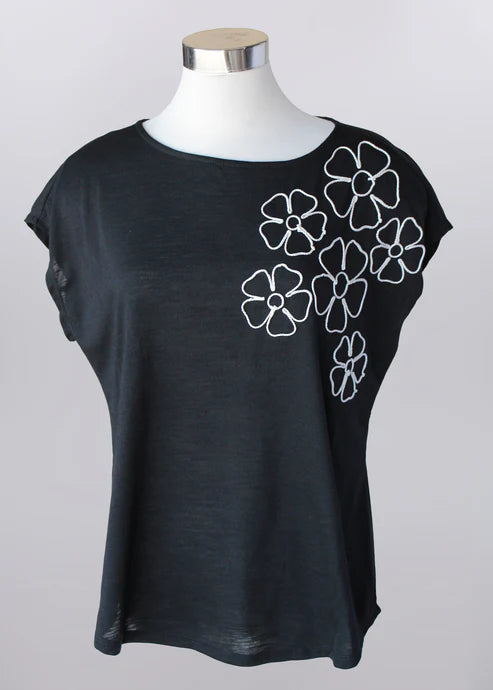 Lightweight black top with white floral textured detail, soft stretch fabric, suitable for church, brunch, and everyday wear