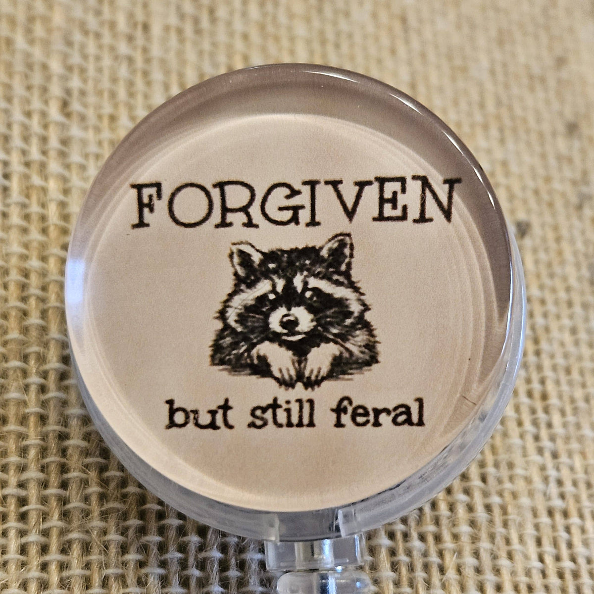 Forgiven But Still Feral Raccoon Badge Reel – Funny Retractable Nurse ID Holder, Acrylic Swivel Badge Clip for Healthcare Workers