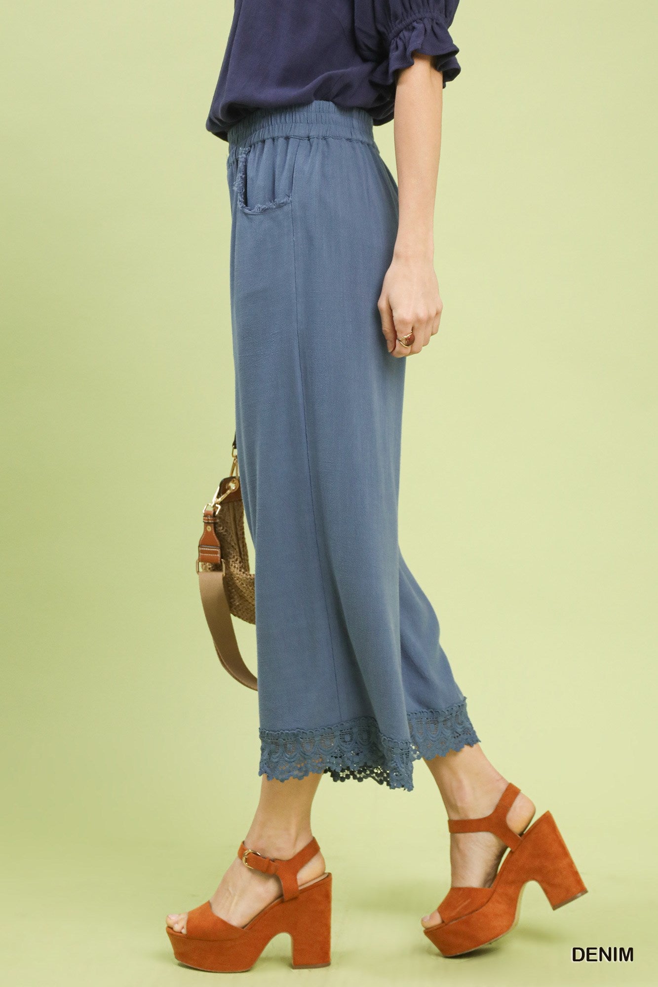 Side view of Umgee Denim Blue linen wide-leg pants showing flowy wide-leg silhouette and lace trim detail.