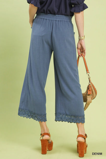 Back view of Umgee Denim Blue linen wide-leg pants with elastic waistband, wide-leg design, and lightweight fabric.