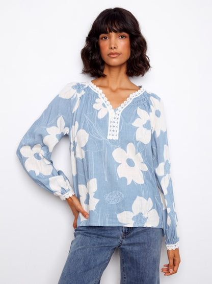 Close-up of floral print and crochet trim on Charlie B Waterlily linen blend blouse, great for garden parties or casual events
