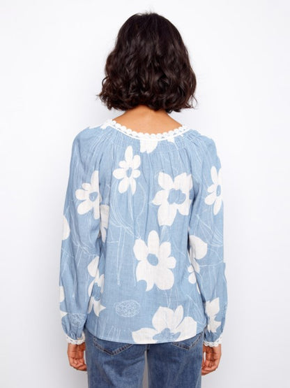 Back view of Charlie B Waterlily printed raglan blouse with crochet detailing, ideal for vacation or weekend outings