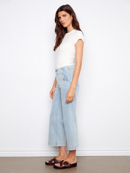 Side view of Charlie B cropped wide leg jeans highlighting relaxed fit and stylish side buttons, perfect for warm-weather travel