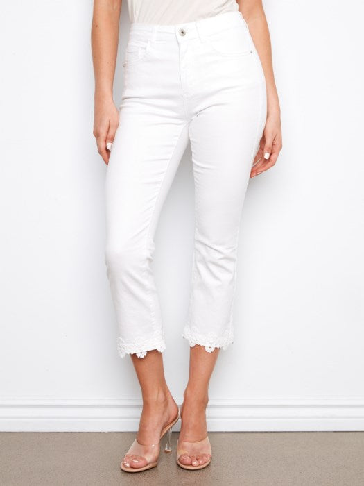 Close-up of floral hem embroidery on Charlie B white cropped flare twill jeans, great for garden parties or casual events