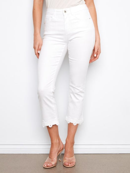 Close-up of floral hem embroidery on Charlie B white cropped flare twill jeans, great for garden parties or casual events