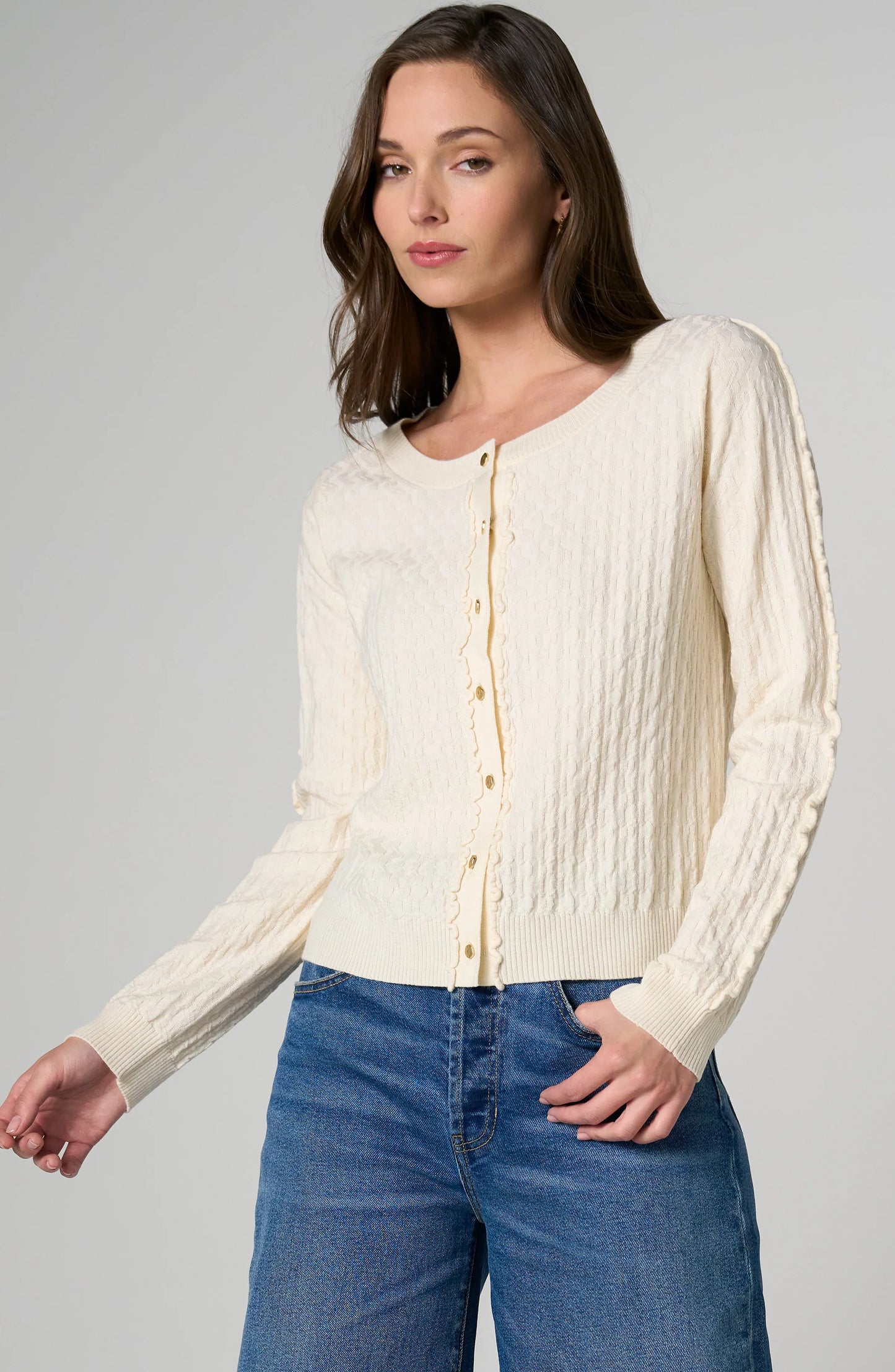 Ruffle Sleeve Soft knit women's button-front cardigan with long sleeves, delicate ruffle details, and ribbed neckline, hem, and cuffs.