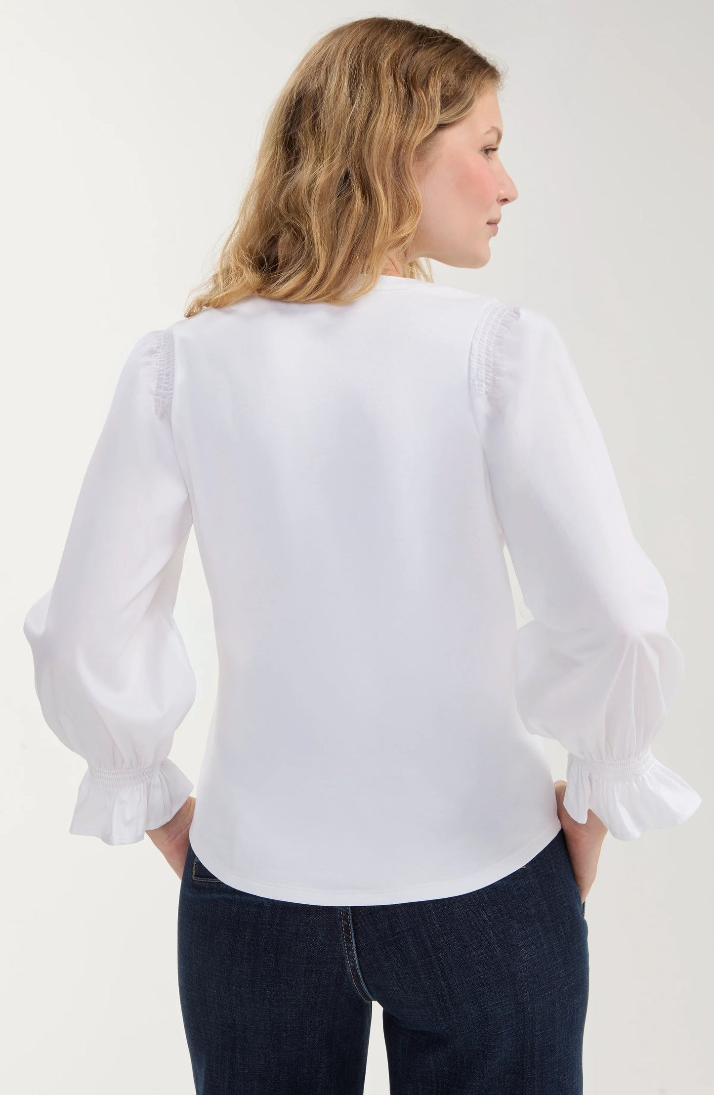Back of Liverpool Women's knit-to-woven boutique top with 3/4 sleeves, split scoop neckline, three-button detail, and elastic sleeve cuffs.