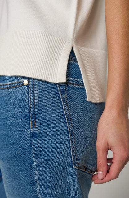 Detail Soft knit women's V-neck dolman sleeve sweater with relaxed fit, short sleeves, stepped hem, and ribbed hem.