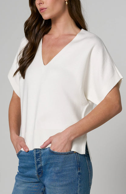Soft knit women's V-neck dolman sleeve sweater with relaxed fit, short sleeves, stepped hem, and ribbed hem.