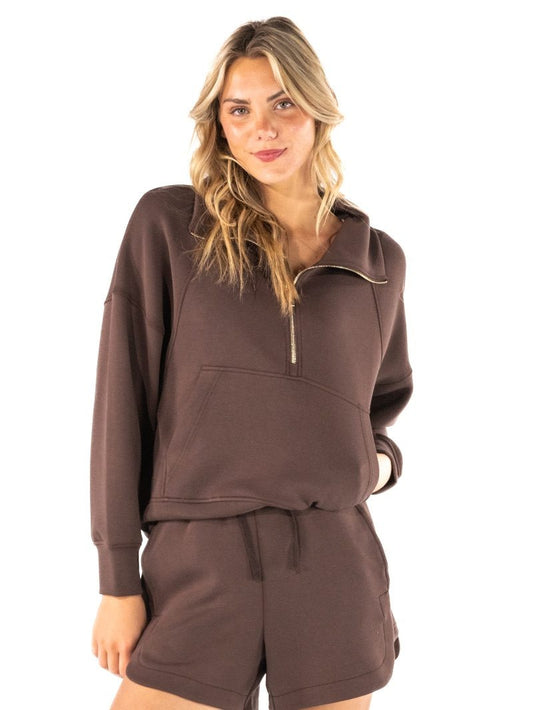 Women's half-zip pullover top with mock neckline, raglan long sleeves, and front kangaroo pocket in a casual, comfortable style.