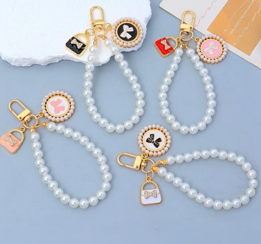 Elegant artificial pearl phone pendant that doubles as a bag charm, wristlet, and keychain.