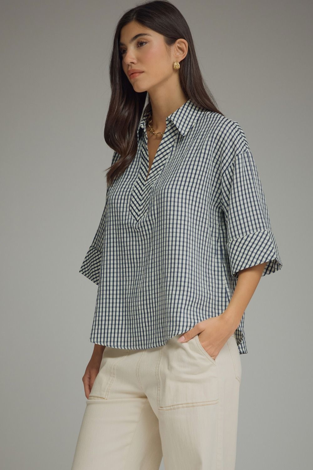 Side Navy and white gingham Entro boutique top available in Missy and Plus Sizes with 3/4 sleeves, V-neck collar, and button cuffs.