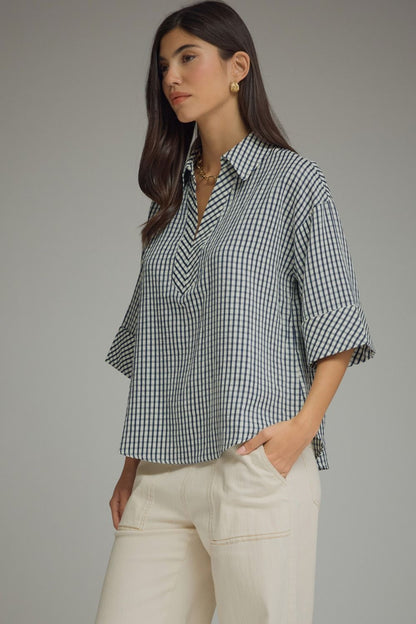 Side Navy and white gingham Entro boutique top available in Missy and Plus Sizes with 3/4 sleeves, V-neck collar, and button cuffs.